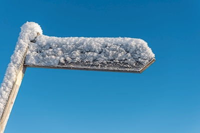 Signpost covered with snow