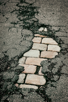Cracked asphalt cobbled street