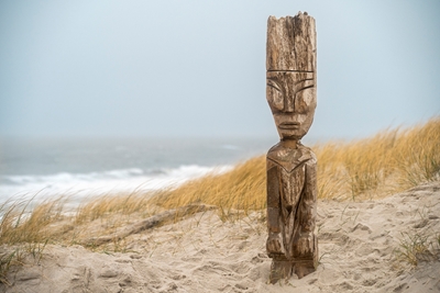 Figurita de madera en la playa