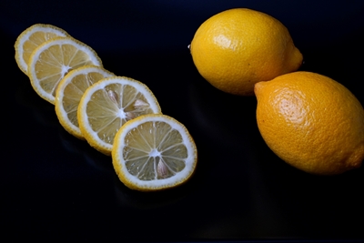Sliced lemon and whole fruit