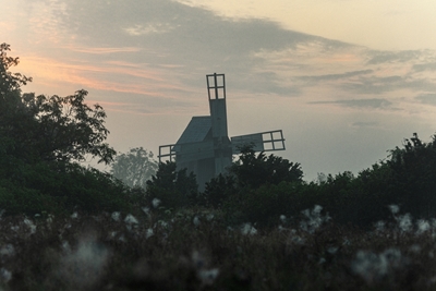 Windmill in the fog of summer