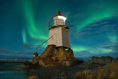 Lighthouse guiding aurora