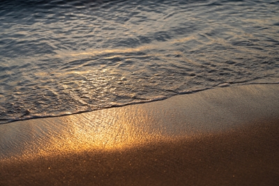 Sea water meets golden sand