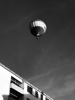 Hot air balloon over building