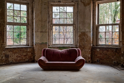 Red sofa in a lost place