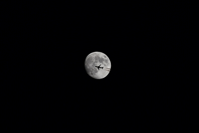 The plane in front of the moon