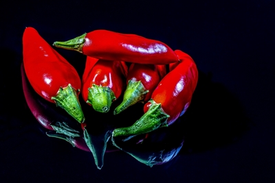 Red chilis on black ground