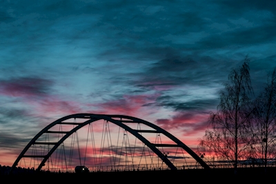 Red blue skies over bridge