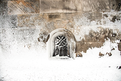 Church window in snowstorm