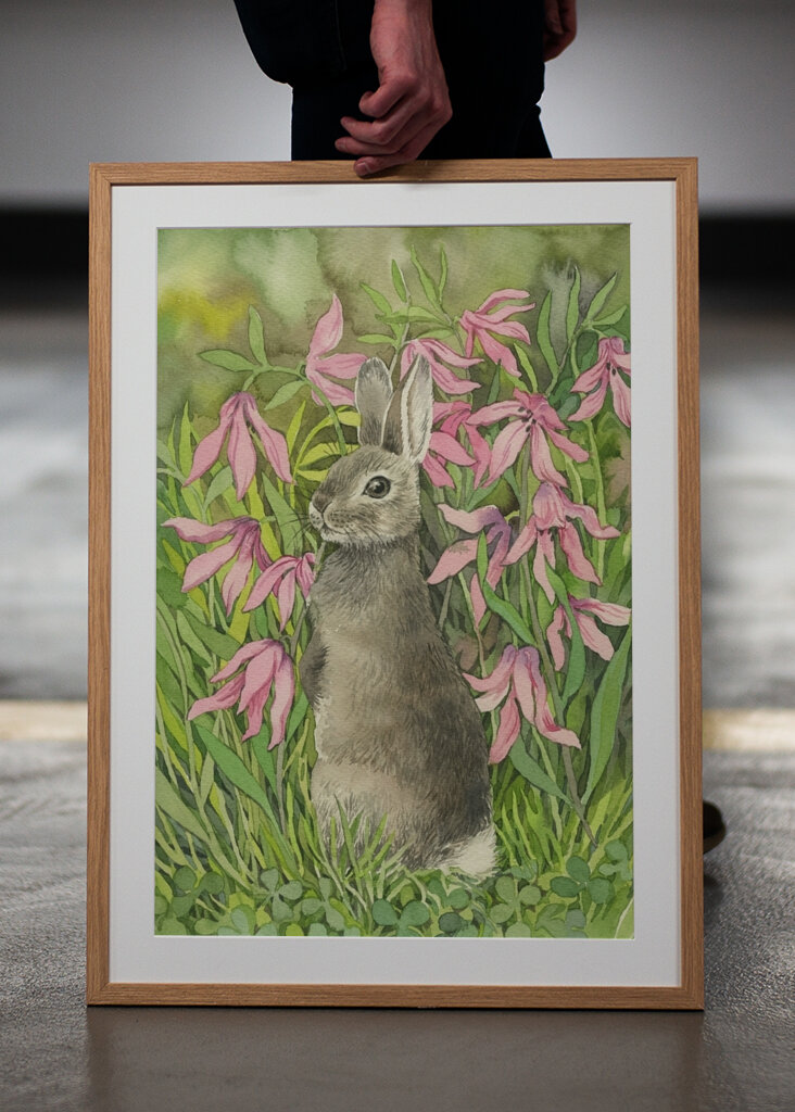 Rabbit among flowers and clove
