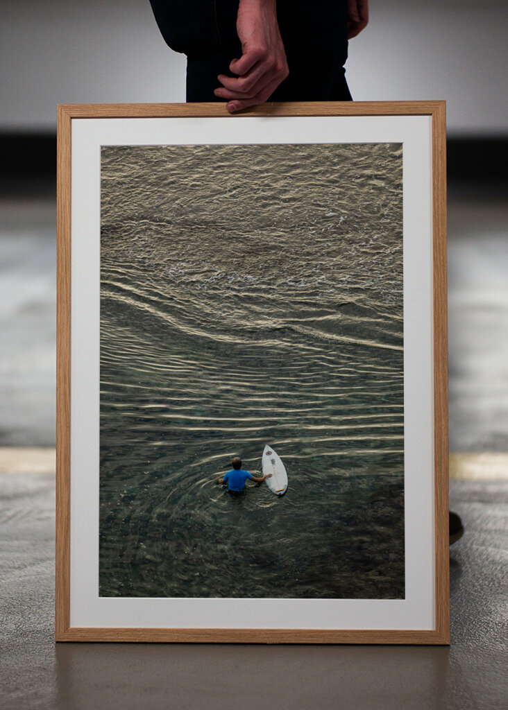 Surfer walking over the reef