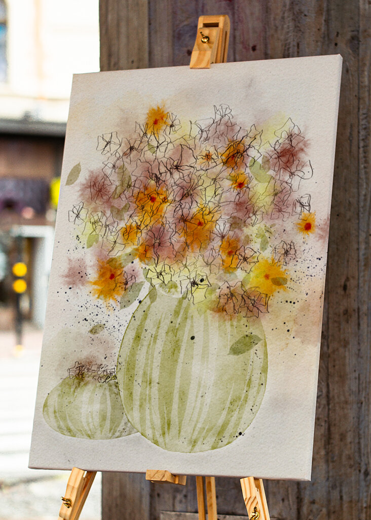 Orange and Yellow Flowers in a Striped Vase