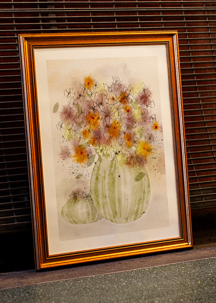 Orange and Yellow Flowers in a Striped Vase